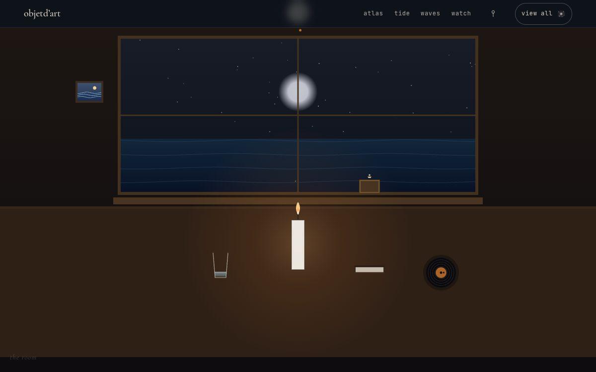 the room — a candle-lit still life at night — a living flame at its center, ringed by small instruments: a clock, a music box, a record, a glass, a book, a window on the sea.